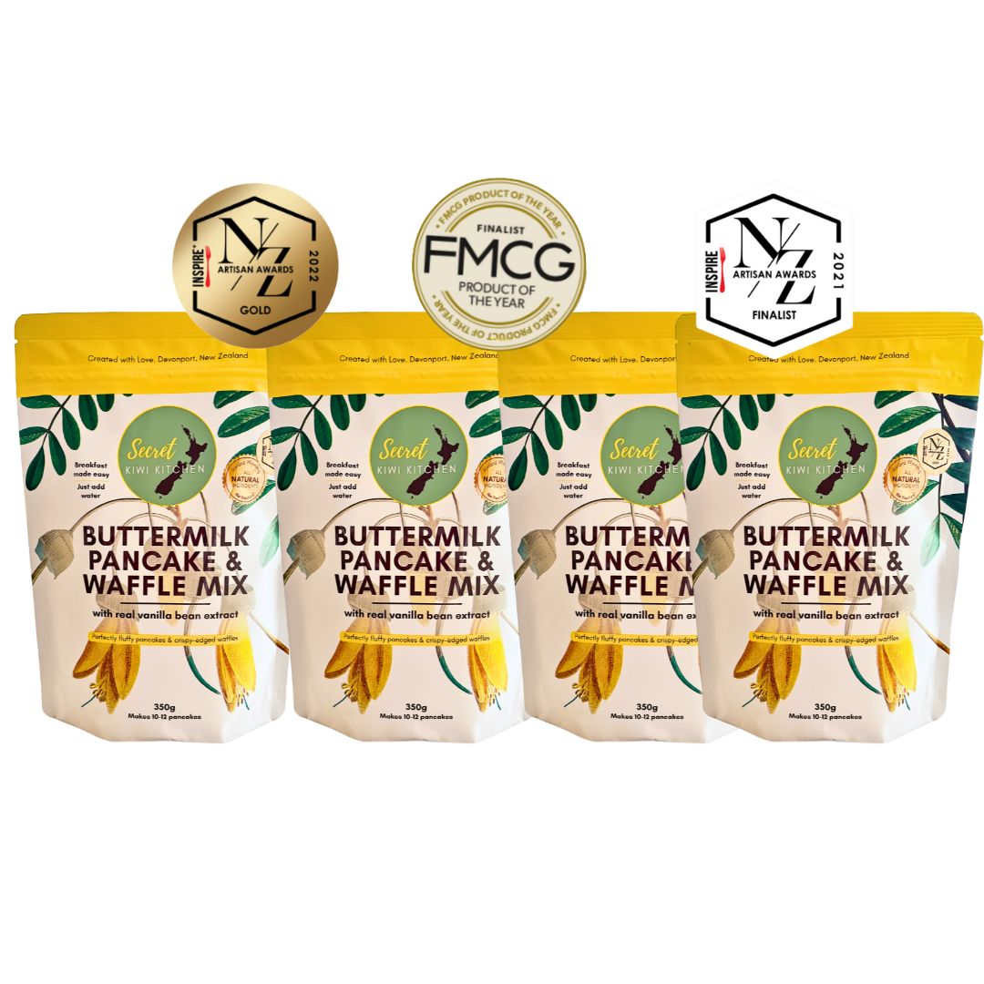 Four packages of Secret Kiwi Kitchen buttermilk pancake and waffle mix with awards on a white background