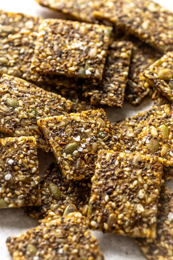 Close-up of Secret Kiwi Kitchenseed crackers on a marble surface